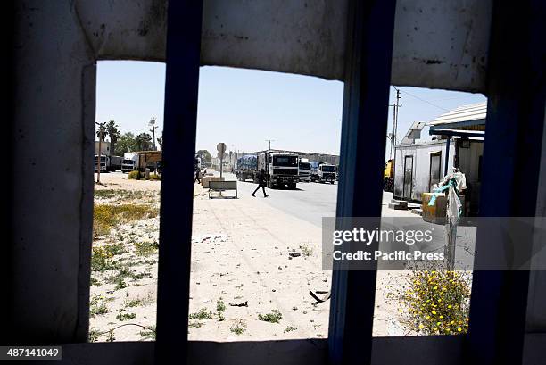 Trucks loaded with food supplies cross into the Palestinian city of Rafah through the Kerem Shalom crossing between Israel and the southern Gaza...