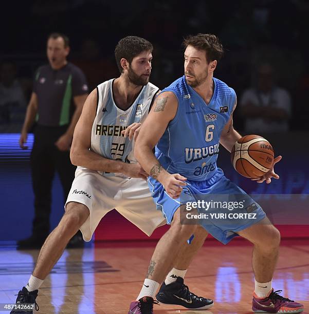 Argentina's small forward Patricio Garino vies for the ball with Uruguay's small forward Mauricio Aguiar during a 2015 FIBA Americas Championship...