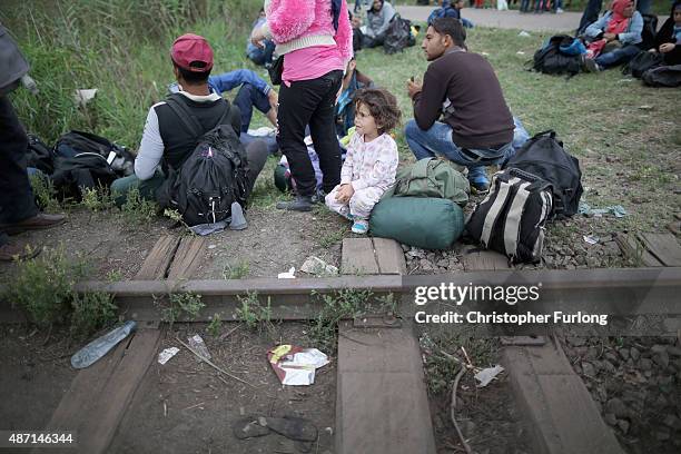 Hundreds of miigrants and refugees continue to cross the border from Serbia into Hungary along the railway tracks close to the village of Roszke on...