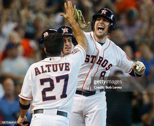 Jed Lowrie of the Houston Astros is congratulated by Jose Altuve, Jake Marisnick and Preston Tucker after hittinga grand slam in the seventh inning...