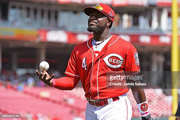 Brandon Phillips of the Cincinnati Reds walks to the dugout after making a fly ball catch to end the top of the fourth inning against the Milwaukee...