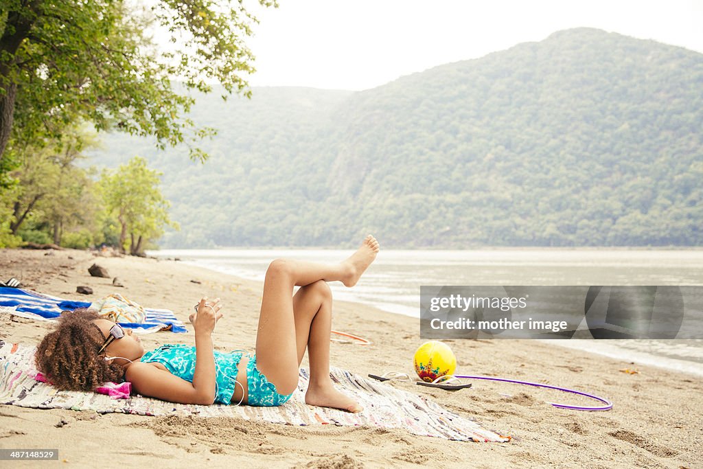 Girl at lake watching video