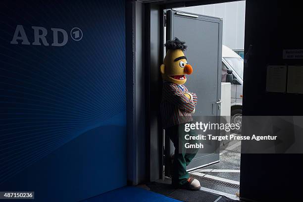 Man dressed as the character Bert from the tv show Sesame Street rests outside the ARD stand at 2015 IFA Tech Fair on September 6, 2015 in Berlin,...