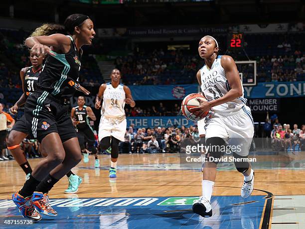 Renee Montgomery of the Minnesota Lynx drives to the basket against Candice Wiggins of the New York Liberty on September 6, 2015 at Target Center in...