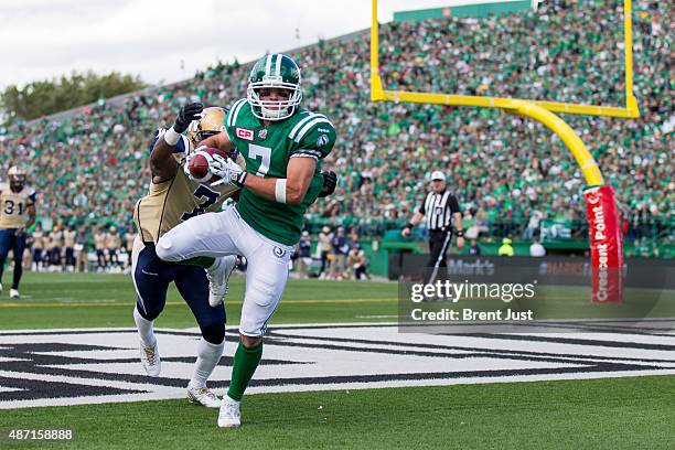 Weston Dressler of the Saskatchewan Roughriders hauls in a pass in the end zone behind Demond Washington of the Winnipeg Blue Bombers that was later...