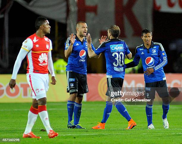Federico Insua of Millonarios celebrates with teammates after scoring the first goal of his team during a match between Santa Fe and Millonarios as...