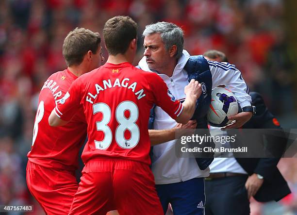 Steven Gerrard and Jon Flanagan of Liverpool have words with Jose Mourinho manager of Chelsea as he holds onto the ball during the Barclays Premier...