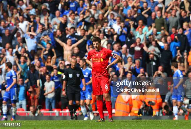 Dejected Steven Gerrard of Liverpool looks on as the Chelsea fans celebrate after Willian of Chelsea scored their second goal during the Barclays...