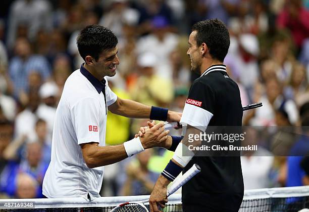 Novak Djokovic of Serbia shakes hands at the net after his four set victory against Roberto Bautista Agut of Spain in their mens singles fourth round...