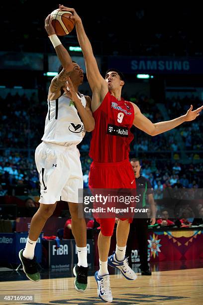 Juan Toscano of Mexico is blocked by Jorge Diaz of Puerto Rico during a second stage match between Mexico and Puerto Rico as part of the 2015 FIBA...
