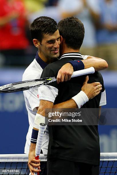Novak Djokovic of Serbia shakes hands at the net after his victory against Roberto Bautista Agut of Spain during their Men's Single Fourth Round...