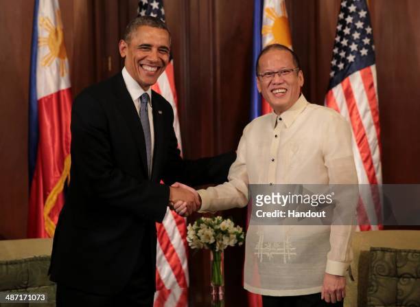 In this handout provided by Malacanang Photo Bureau', US president Barack Obama shakes hands with Philippine President Benigno Aquino at the...