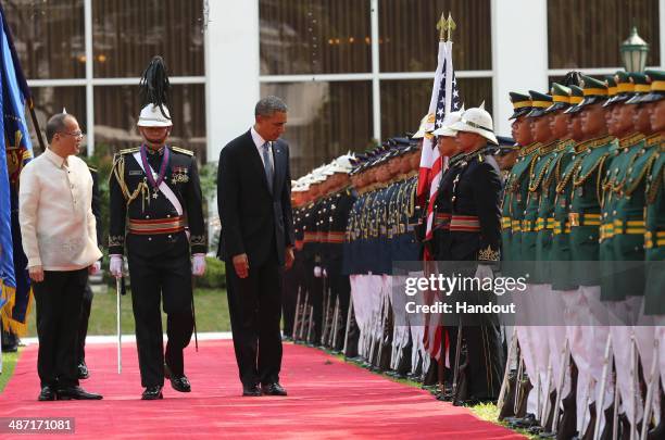 In this handout provided by Malacanang Photo Bureau', US president Barack Obama and Philippine President Benigno Aquino review the honor guard at the...