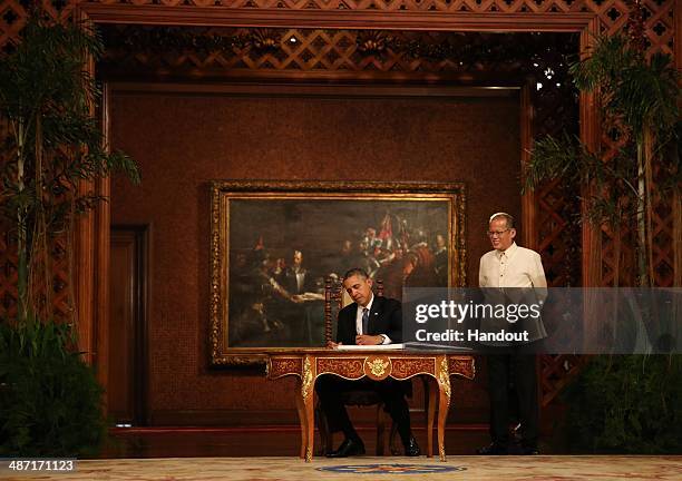 In this handout provided by Malacanang Photo Bureau', US president Barack Obama signs the palace guestbook during his two-day State visit at the...