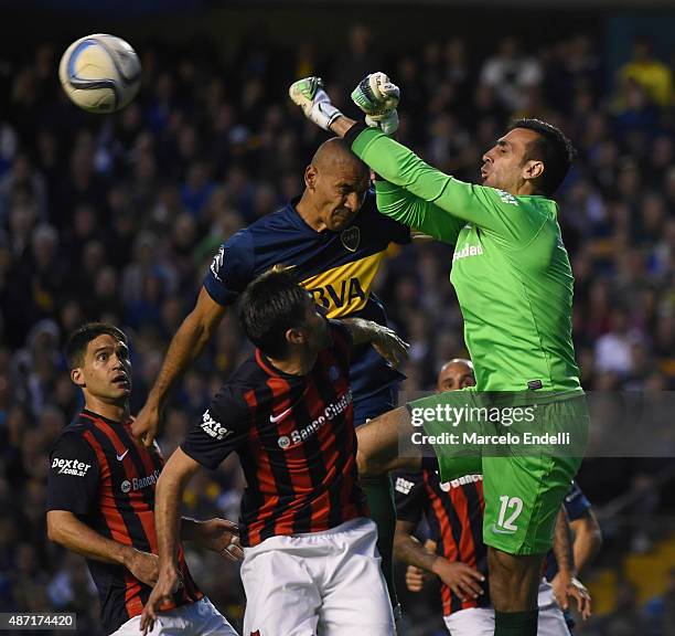 Sebastian Torrico of San Lorenzo and Daniel Diaz of Boca Juniors jump for the ball during a match between Boca Juniors and San Lorenzo as part of...