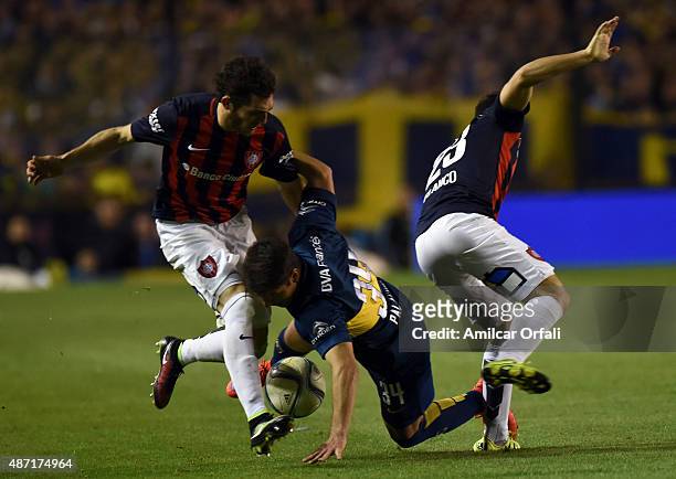 Sebastian Palacios of Boca Juniors fights for the ball with Sebastian Blanco and Ramiro Arias of San Lorenzo during a match between Boca Juniors and...