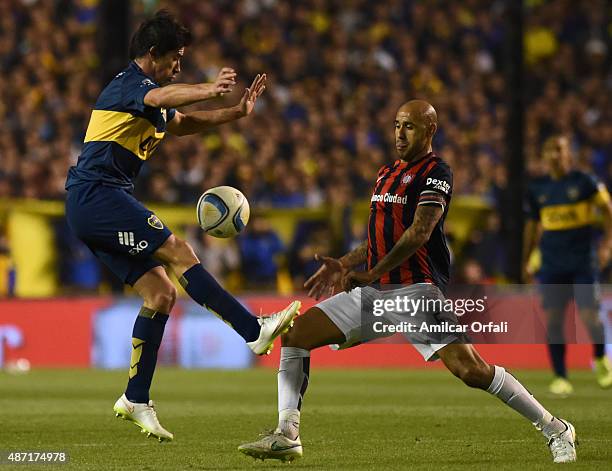 Pablo Perez of Boca Juniors and Juan Ignacio Mercier of San Lorenzo figth for the ball during a match between Boca Juniors and San Lorenzo as part of...