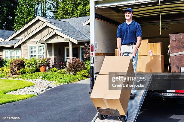 delivery man unloading truck - man boxes moving home stock pictures, royalty-free photos & images