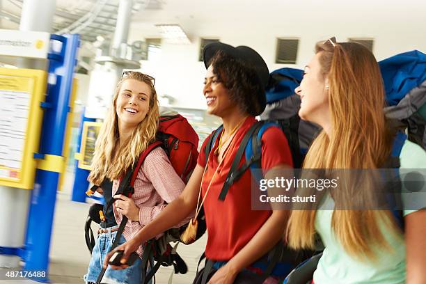 backpacking friends in terminal building - touring music festival stock pictures, royalty-free photos & images