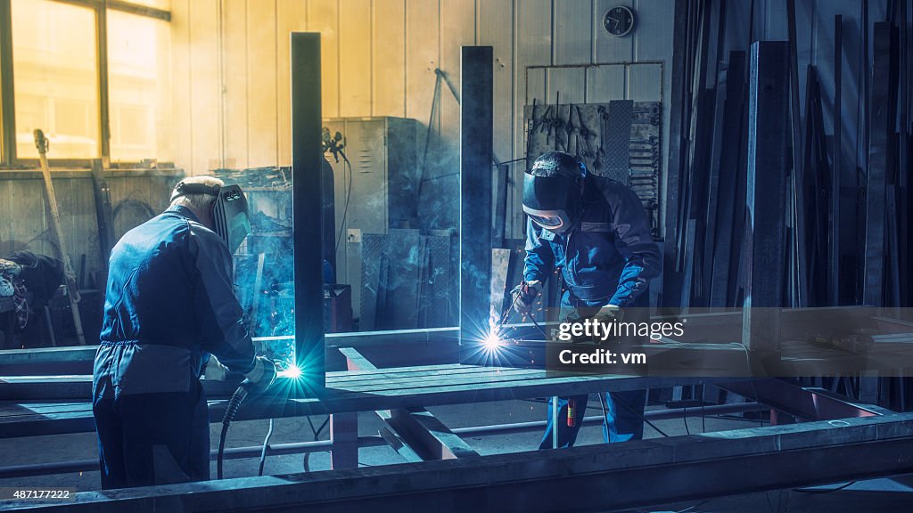 Industrial workers with welding tools