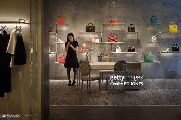 To go with 'SKorea-fashion-entertainment',FEATURE by Jung Ha-Won In a photo taken on June 17, 2015 a sales assistant stands in a new Dior showroom in...