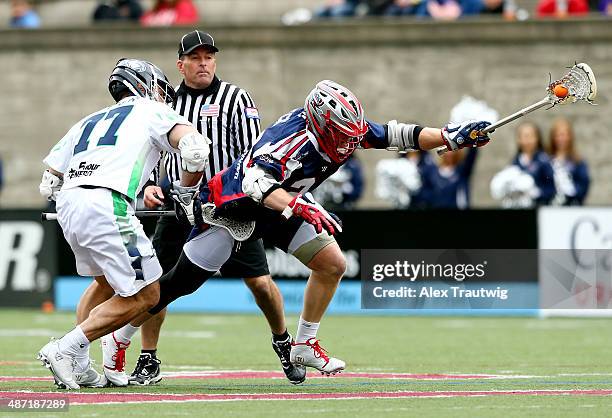 Chris Eck of the Boston Cannons tries to gain control of the ball as Stephen Peyser of the Chesapeake Bayhawks defends during a game at Harvard...