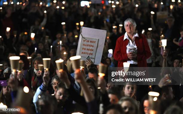 Protesters hold placards and candles to remember Syrian child Aylan Kurdi, who drowned in Turkey last week creating an international outcry, during a...