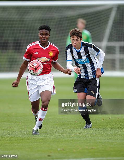 Tyrell Warren of Manchester controls the ball whilst being pursued by Lewis McNall of Newcastle during the Under 18 Barclays Premier League match at...