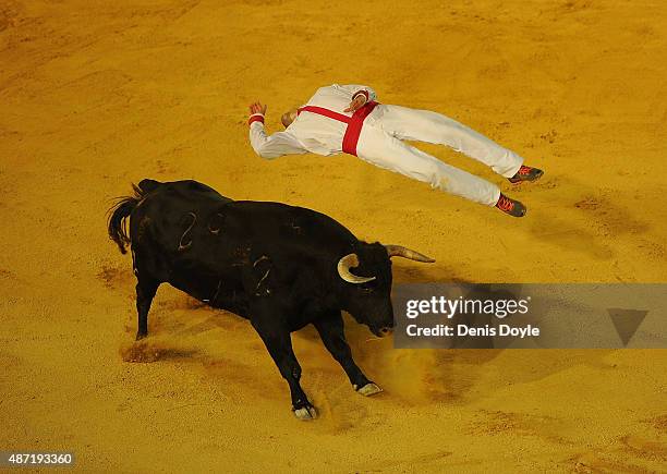 Guillaume Vergonzeanne of the French Recortadores company Passion Saltador leaps over a charging bull at the end of the Liga de Corte Puro finals at...