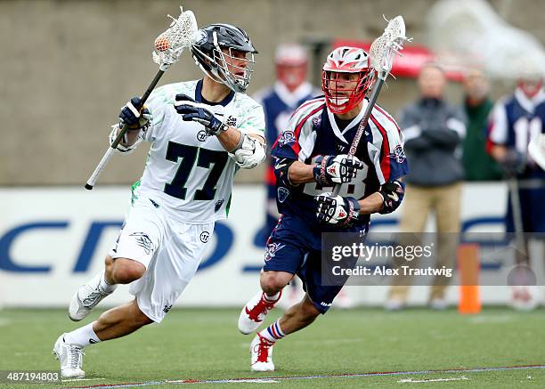 Stephen Peyser of the Chesapeake Bayhawks carries the ball as Brent Adams of the Boston Cannons defends during a game at Harvard Stadium on April 27,...