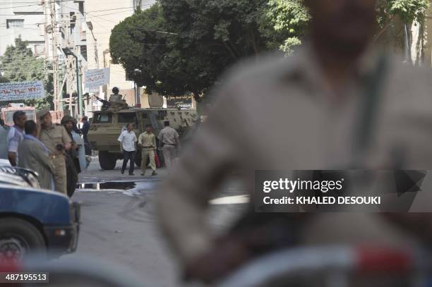 Members of the Egyptian security forces monitor the streets in the southern city of Minya on April 28 after a court sentenced 682 alleged Islamists...