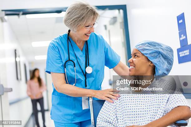 nurse taking patient to recovery after outpatient surgical procedure - surgery bildbanksfoton och bilder