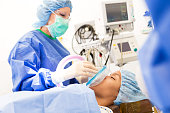 Patient being sedated by anesthesiologist before surgical procedure