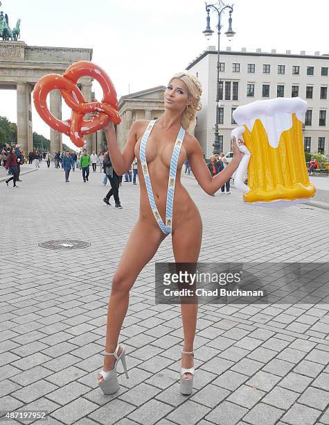 Model Micaela Schaefer poses for photographers at Brandenburg Gate on September 7, 2015 in Berlin, Germany.