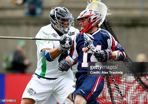 Nicky Polanco of the Chesapeake Bayhawks defends against Ryan Boyle of the Boston Cannons during a game at Harvard Stadium on April 27, 2014 in...