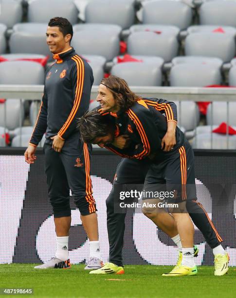 Luka Modric 8front) fights with team mate Fabio Coentrao during the Real Madrid training session ahead of their UEFA Champions League semi-final...