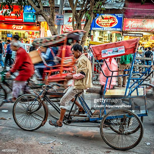 men riding their rickshaws at old delhi spice market - chandni chowk stockfoto's en -beelden