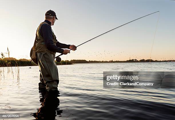 fly fisherman watching flock of birds fly past - people portraits hobbies stock pictures, royalty-free photos & images