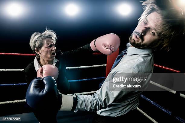 fight between businessman and businesswoman - knockout punch stock pictures, royalty-free photos & images