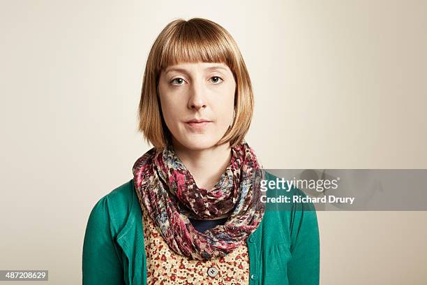 portrait of serious young woman looking to camera - ausdruckslos stock-fotos und bilder