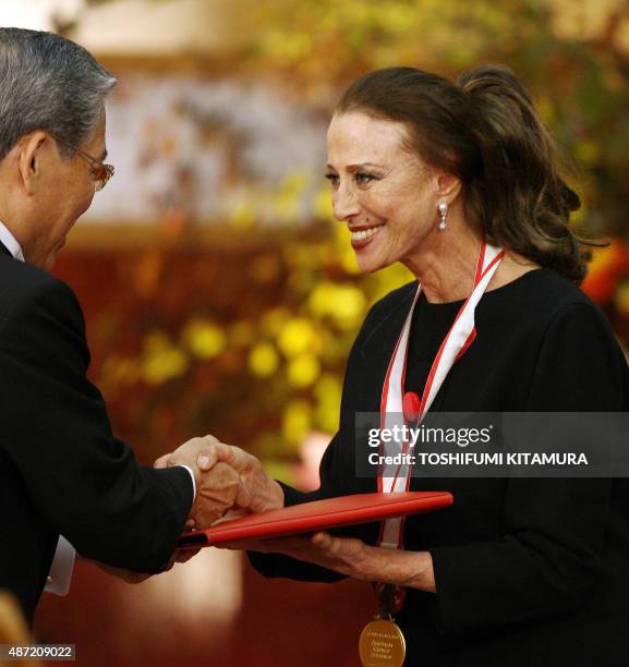 Russian dancer Maya Plisetskaya receives the winning certificate and prize money in the Theatre/film section from Hisashi Hieda, a Vice Chairman of...