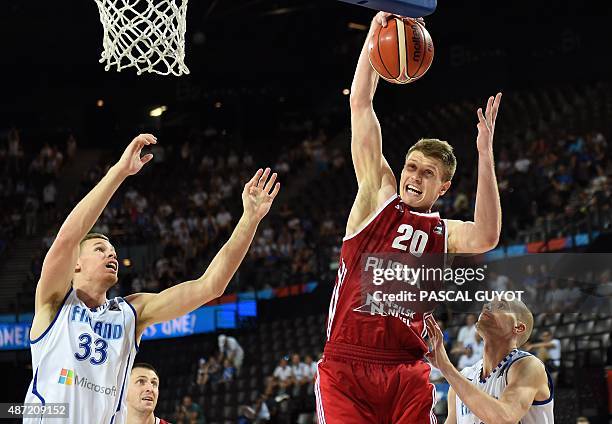 Russia's Andrey Vorontsevich vies with Finland's Tuukka Kotti and Finland's Erik Jay Murphy during the group A qualification basketball match between...