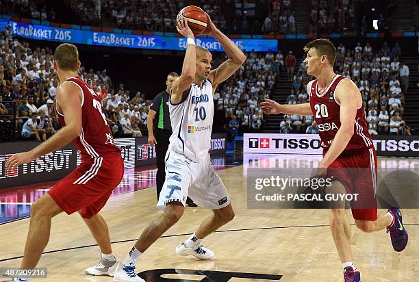 Finland's Tuukka Kotti vies with Russia's Andrey Vorontsevich and Russia's Sergey Monya during the group A qualification basketball match between...