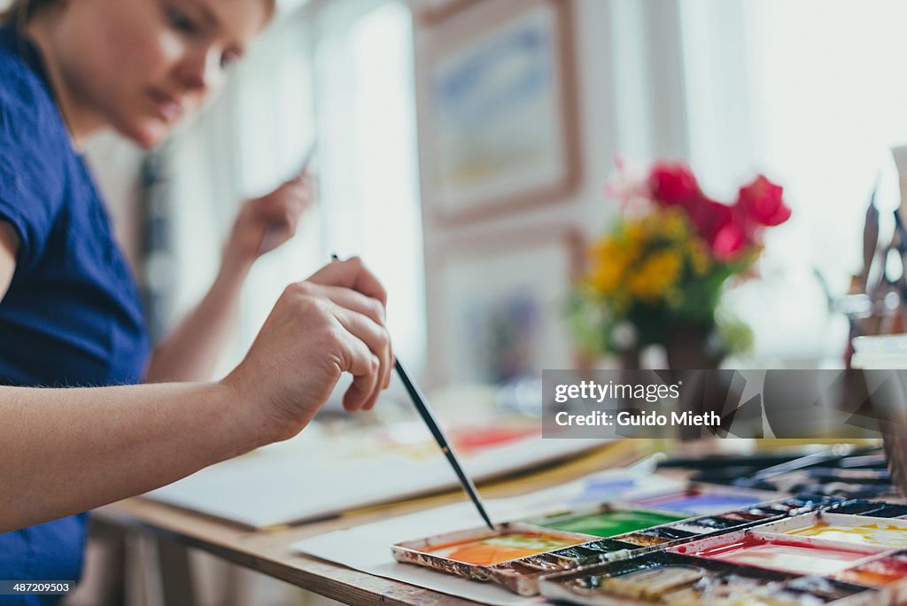 Woman painting watercolour.