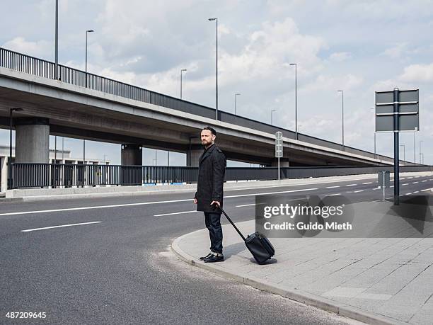 lonely man standing in urban scene. - man side way looking stock pictures, royalty-free photos & images