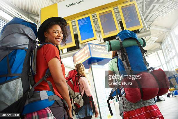 backpacking friends in terminal building - gap year stock pictures, royalty-free photos & images