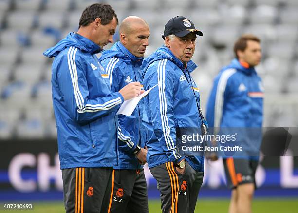 Assistant-coaches Paul Clement and Zinedine Zidane, and the head-coach of Real Madrid Carlo Ancelotti direct the training session on the eve of the...
