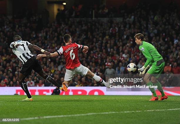 Laurent Koscielny shoots past Newcastle goalkeeper Tim Krul to score for Arsenal during the Barclays Premier League match between Arsenal and...