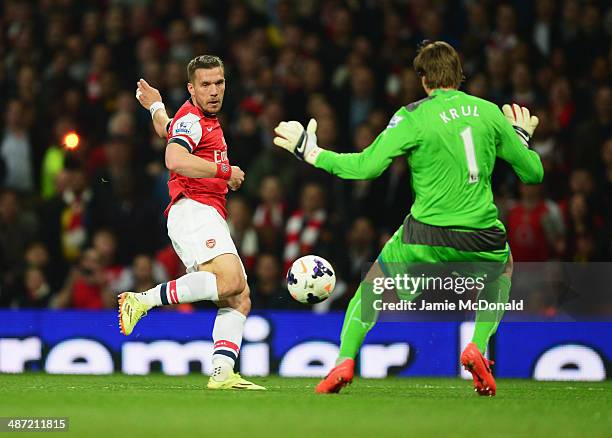 Lukas Podolski of Arsenal is faced by goalkeeper Tim Krul of Newcastle United during the Barclays Premier League match between Arsenal and Newcastle...