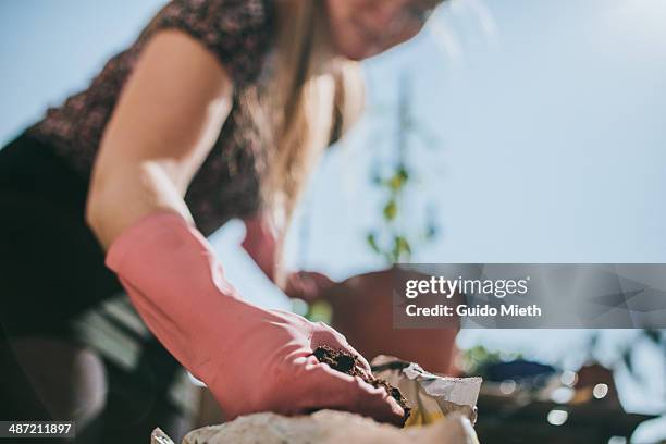 Woman Planting On Balcony High-Res Stock Photo